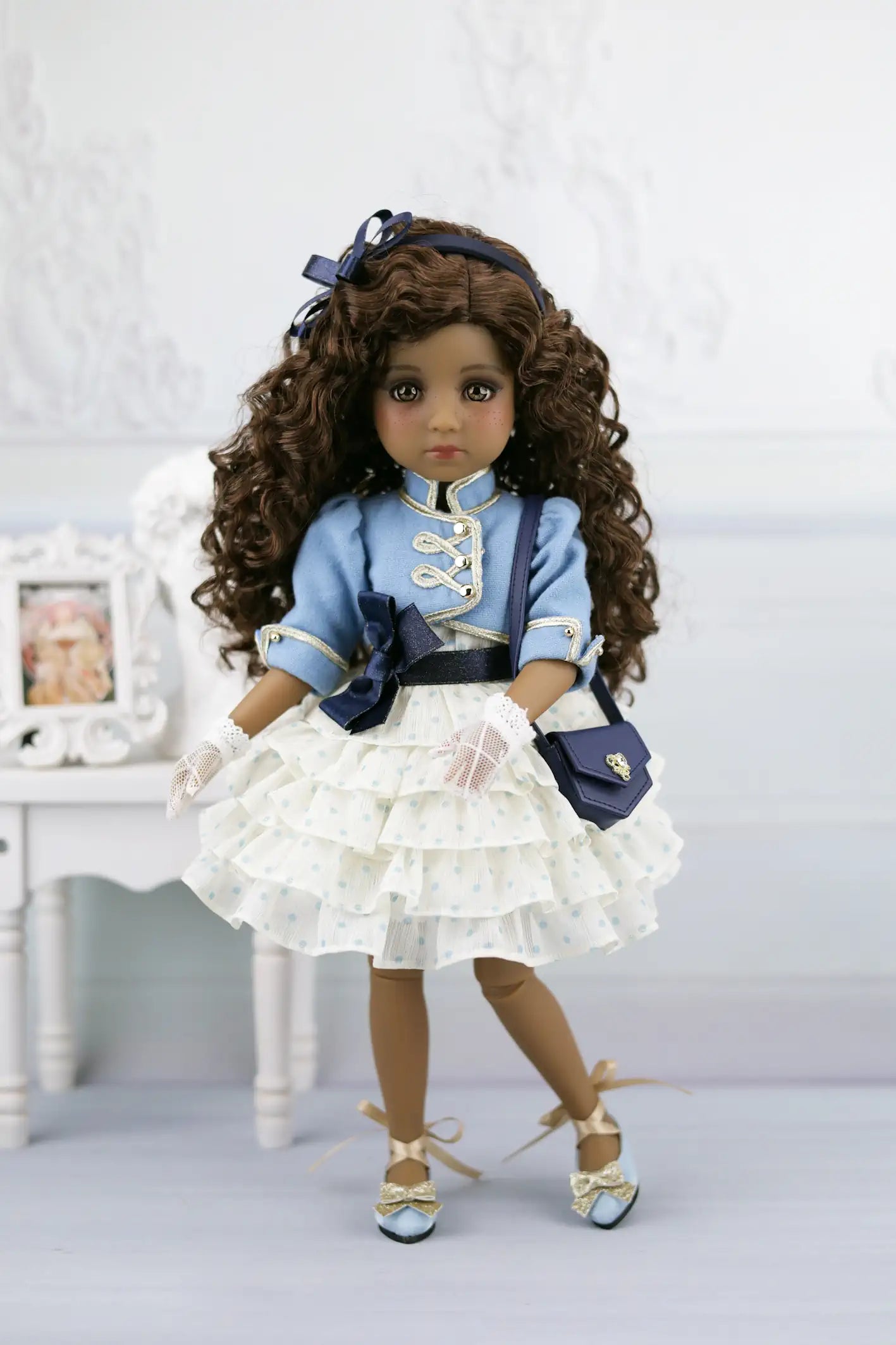 Ruth in a blue outfit with a white background