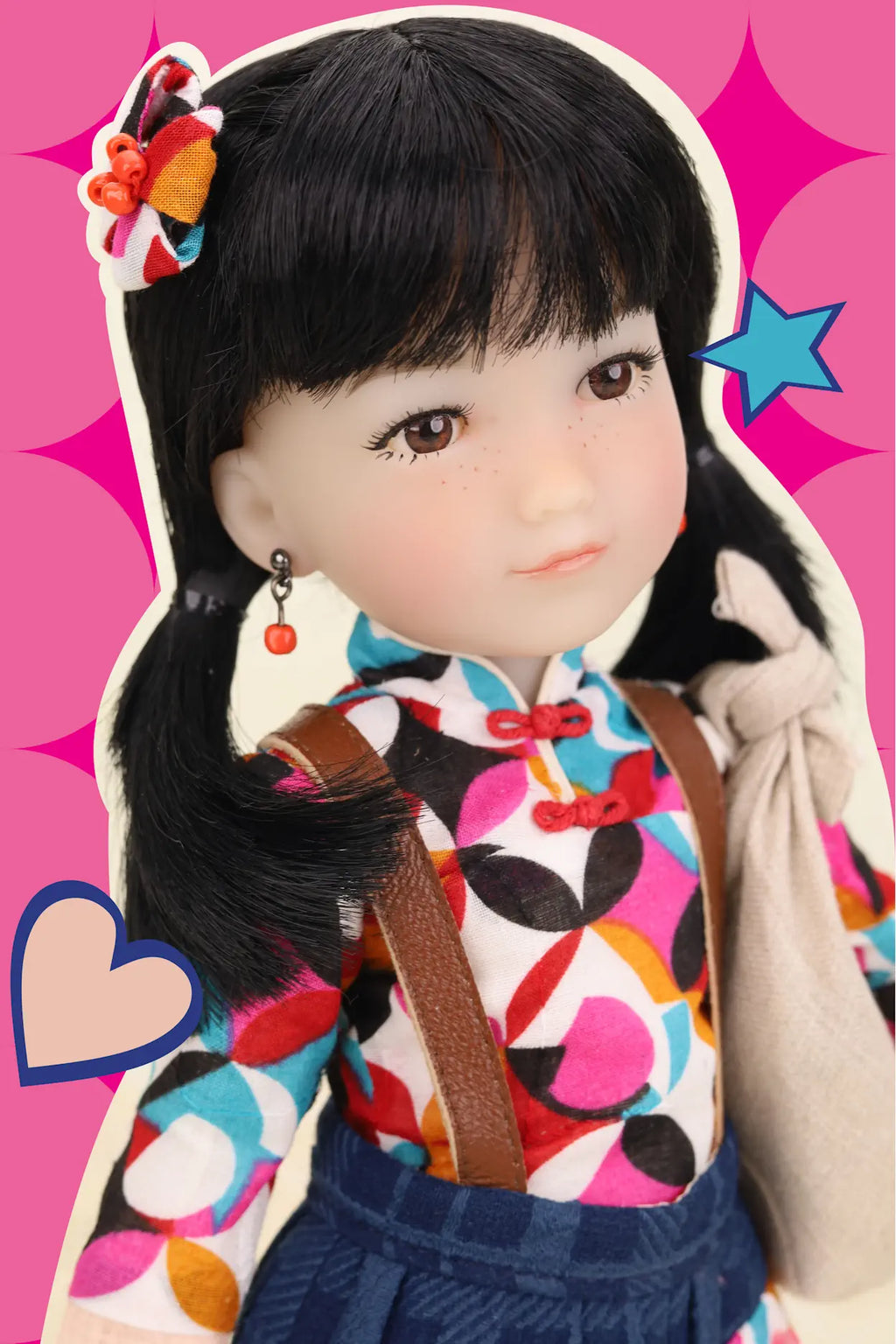 Doll with colorful outfit and accessories on a pink background