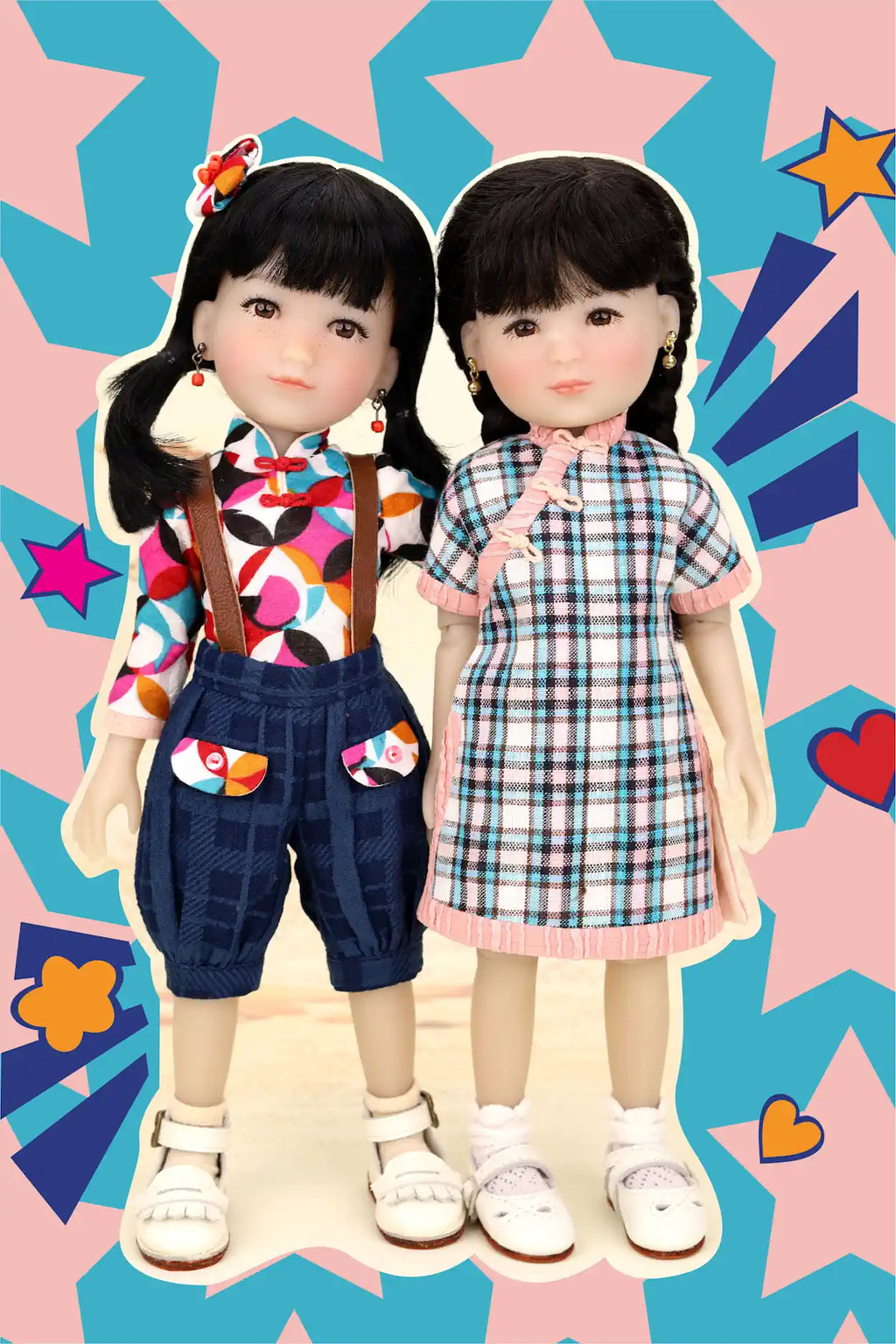 Two dolls standing side by side against a colorful star and heart patterned background.