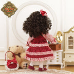 Doll in a red dress with curly hair in a room with a teddy bear and furniture.