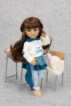 8" mini Fashion Friends doll with long brown hair wearing a white sweater with a bear design, blue skirt, and beige shoes on a gray background.