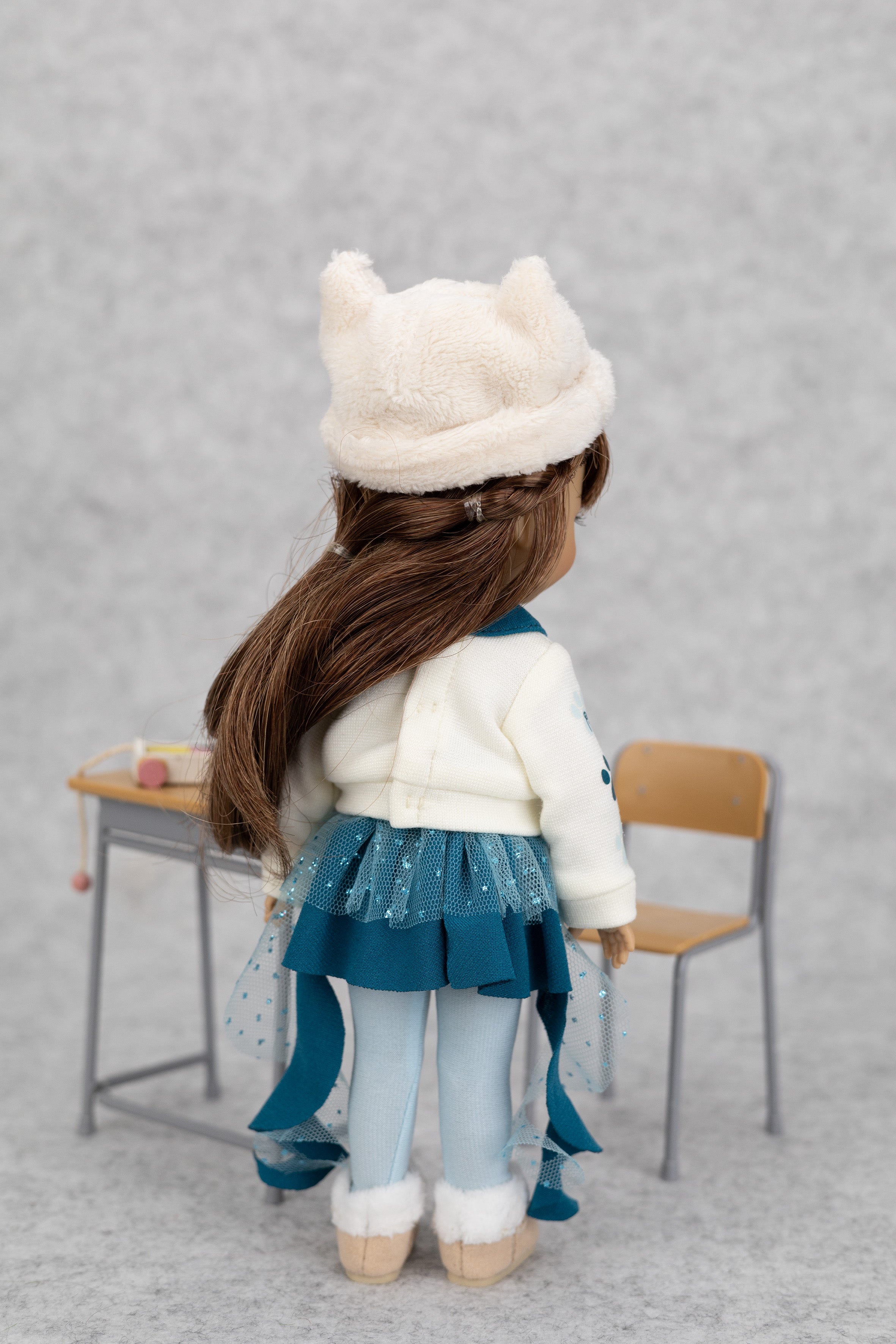 8" mini Fashion Friends doll wearing a white coat, blue skirt, and white hat with animal ears, standing in front of a gray background.