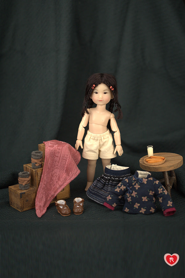 Doll with accessories on a dark background