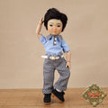 Doll wearing a blue shirt and checkered pants with a brown background