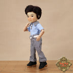 Doll wearing a blue shirt and checkered pants on a beige background with 'Ruby Red Dolls' logo.