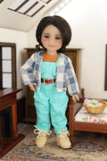 mini Freida doll standing dressed in Turquoise Adventure Outfit standing in a room with furniture and decor