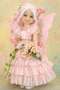 A doll  of a fairy girl with long white and pink hair, pink wings, and a pink floral dress, holding a bouquet of flowers against a soft pastel background.
