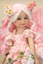 A doll with long white hair, pink fairy wings, and a pink floral dress, styled with daisy and pink flowers in her hair, set against a soft beige background.