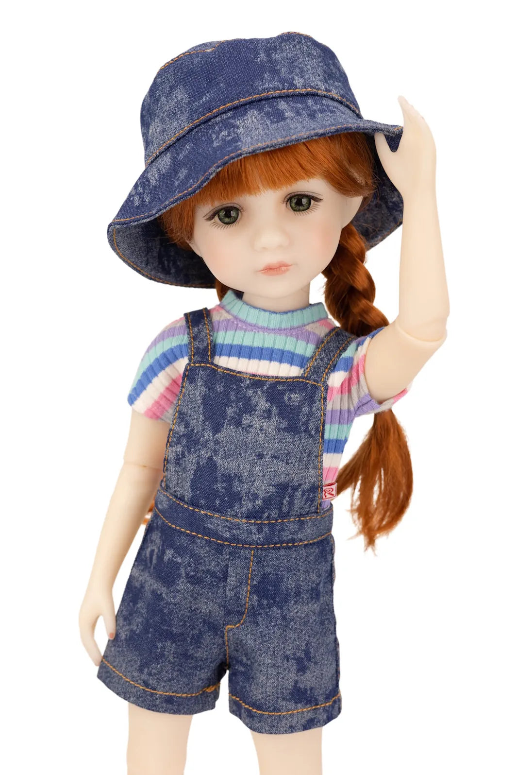 Doll wearing a denim outfit with a hat on a white background