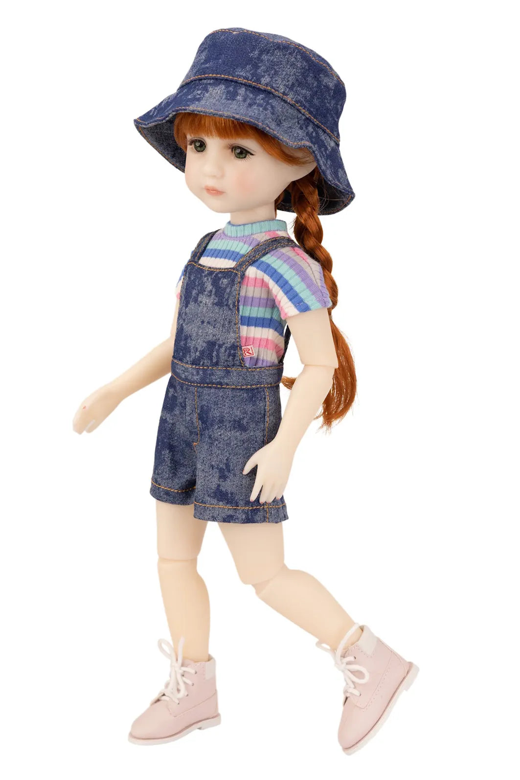 Doll wearing a denim outfit with a hat on a white background