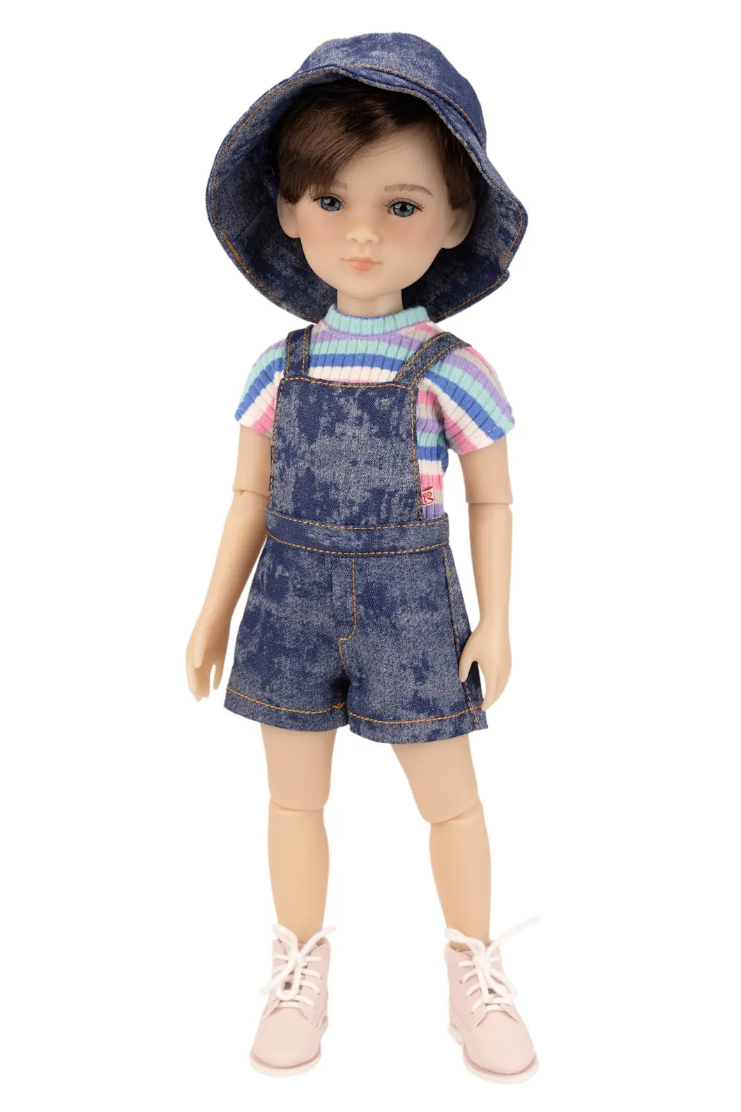 Doll wearing a denim outfit with a hat on a white background