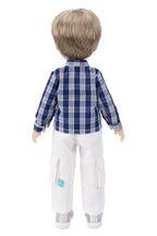 Doll wearing a blue plaid shirt and white pants on a white background