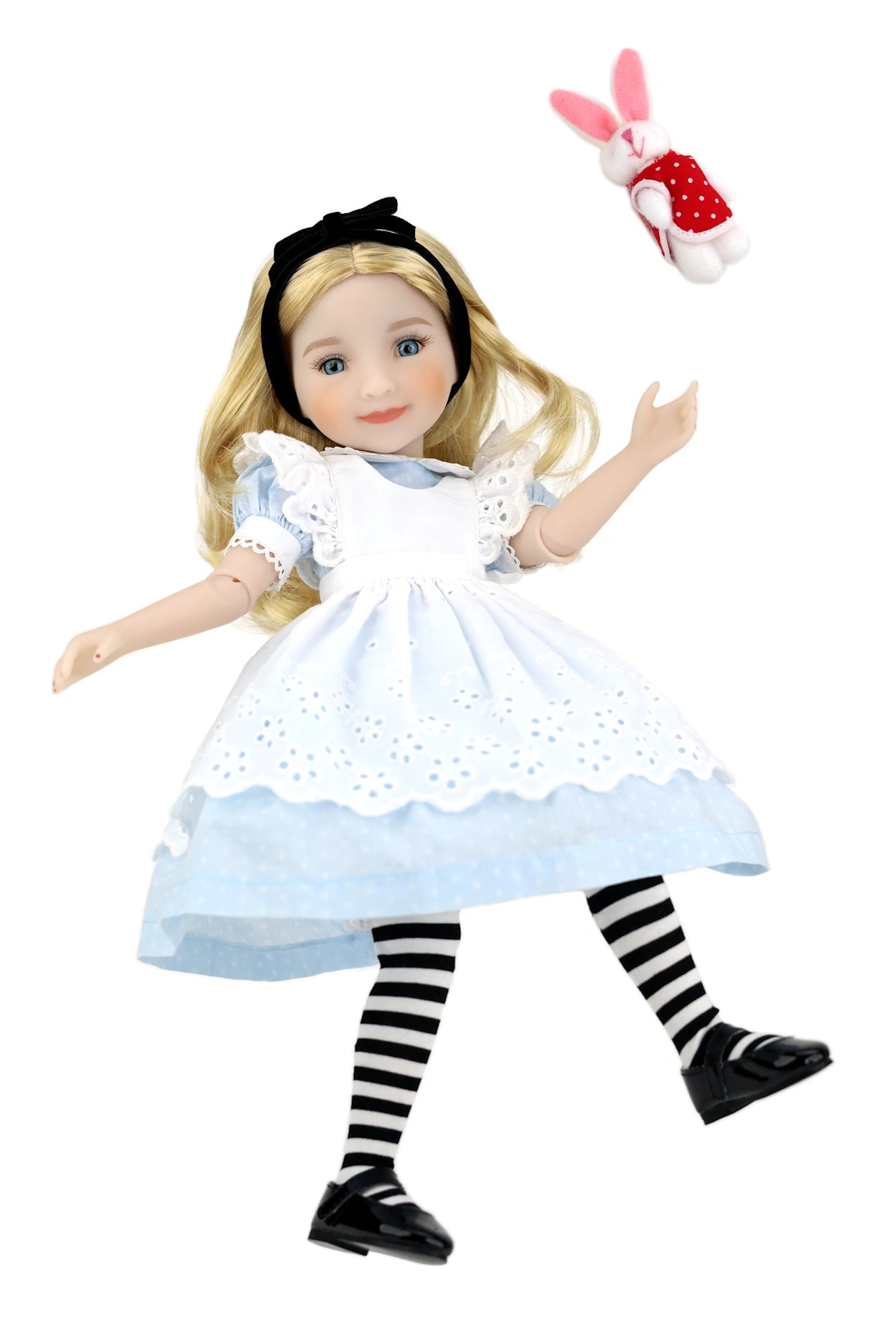 Doll dressed as Alice from Wonderland with striped socks and a white rabbit toy on a white background