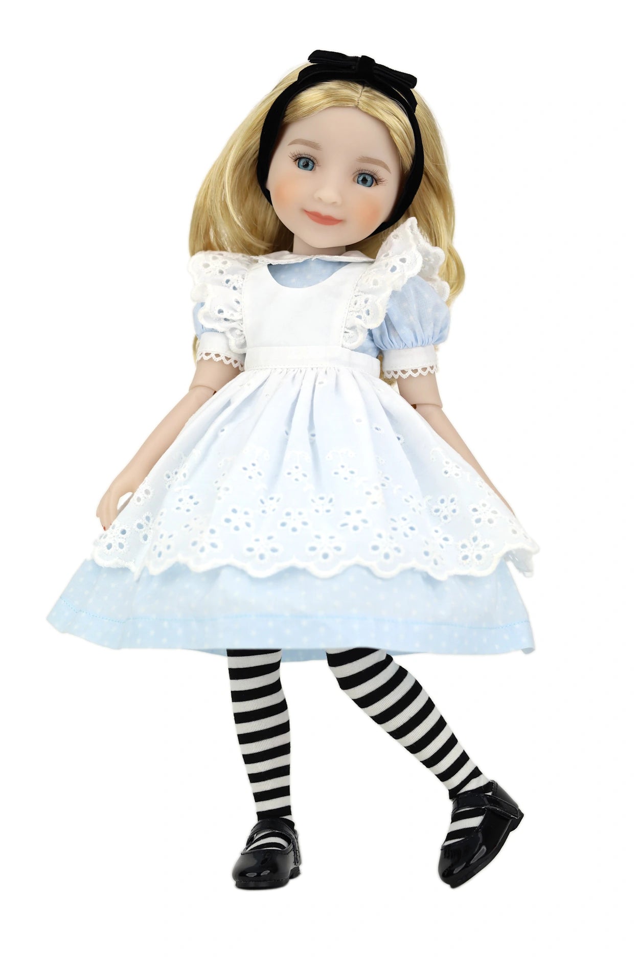 Doll dressed as Alice in Wonderland with a white dress and striped stockings on a white background