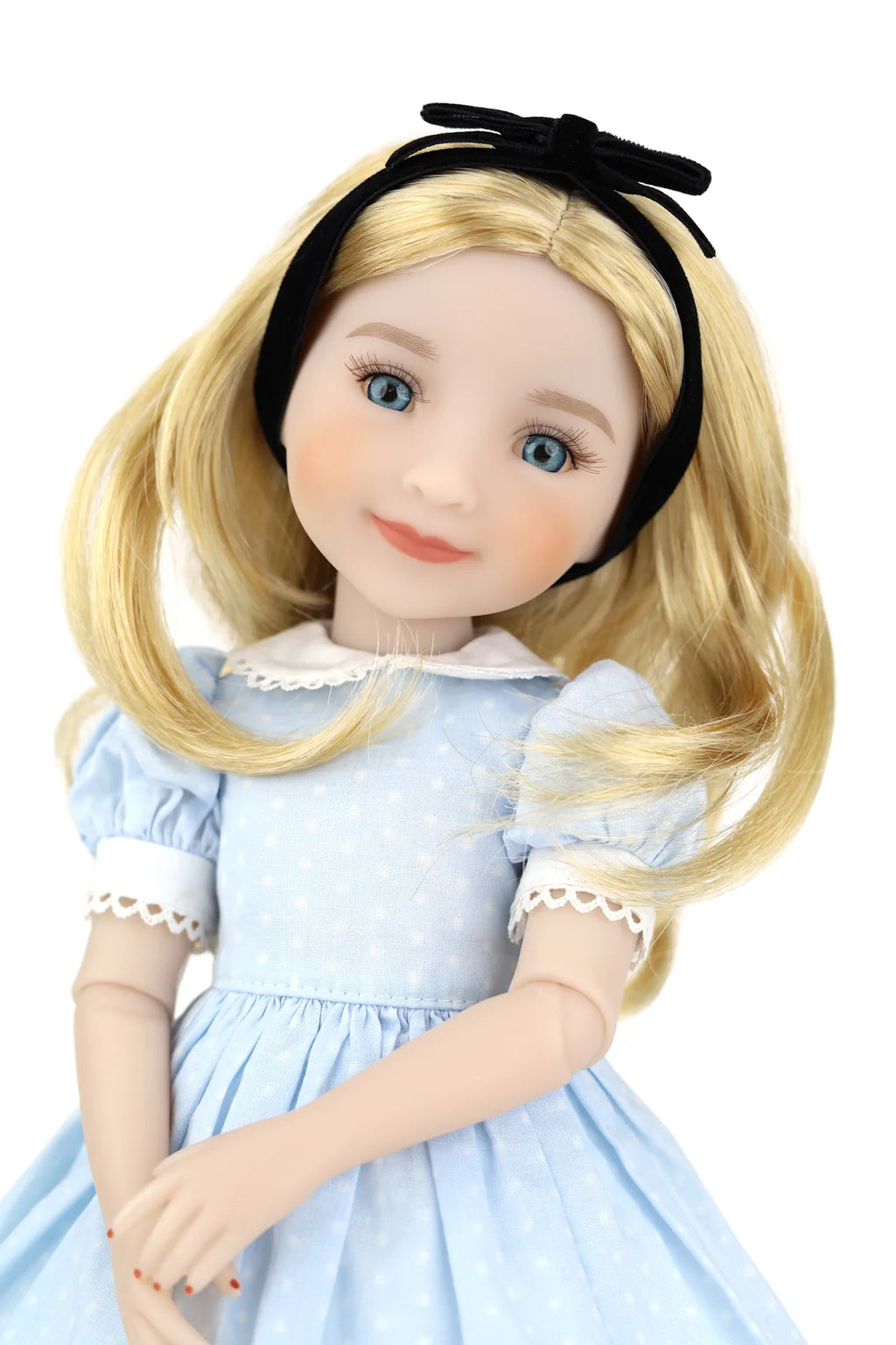 Doll with blonde hair and a blue dress on a white background