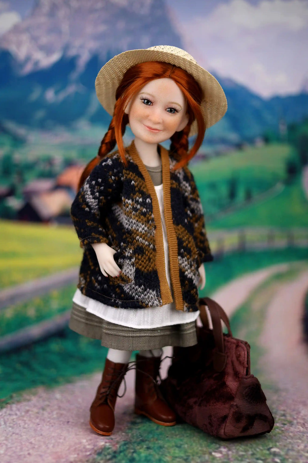 Doll with a patterned jacket and straw hat standing on a scenic background