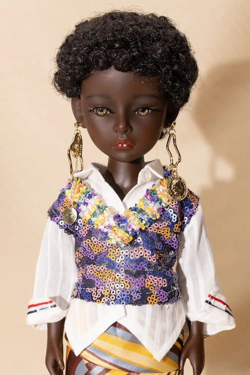 Doll wearing a colorful sequined vest over a white shirt on a beige background
