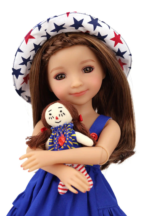 Doll wearing a blue dress and star-patterned hat, holding a smaller doll.