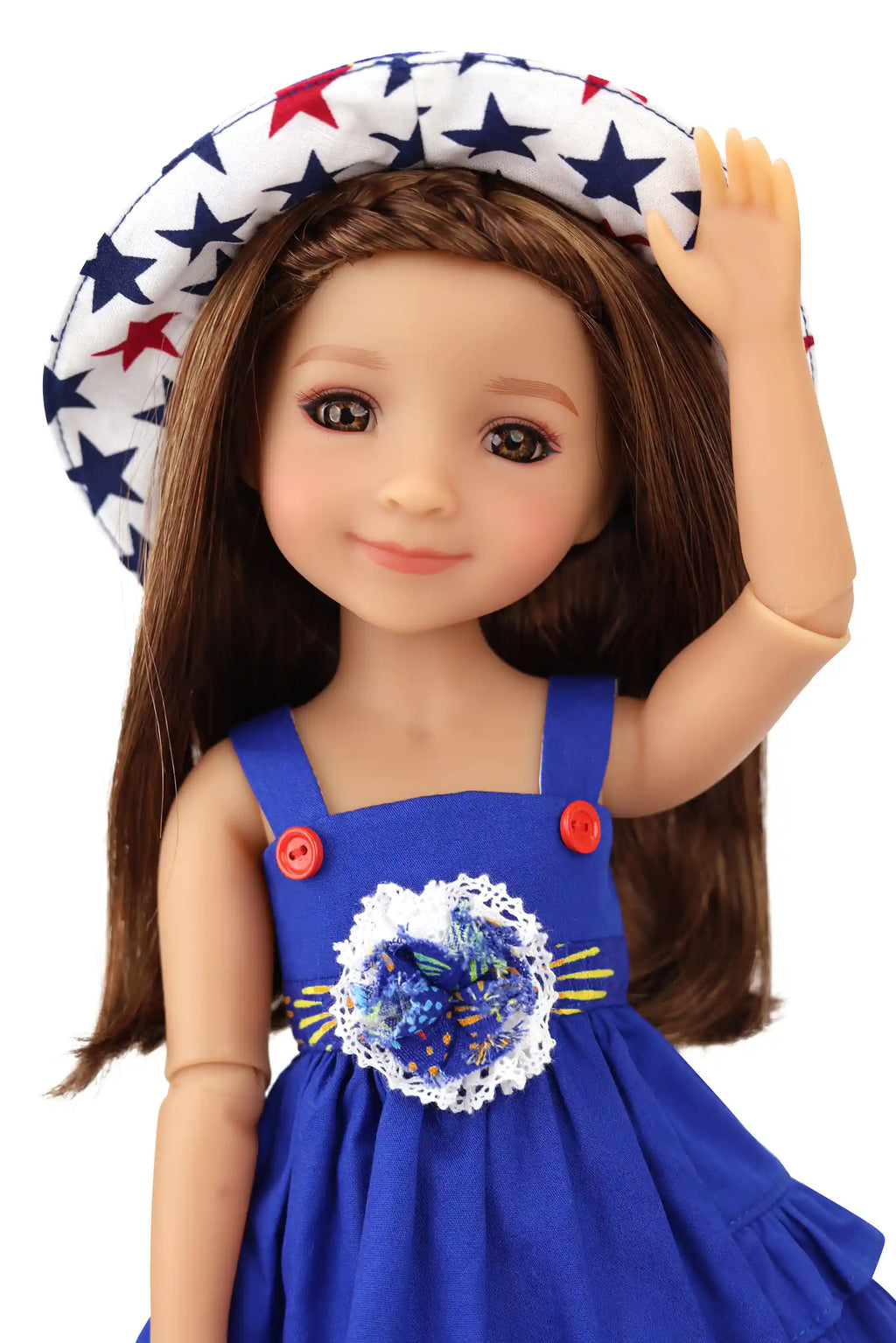 Doll wearing a blue dress with a decorative center and a star-patterned hat on a white background
