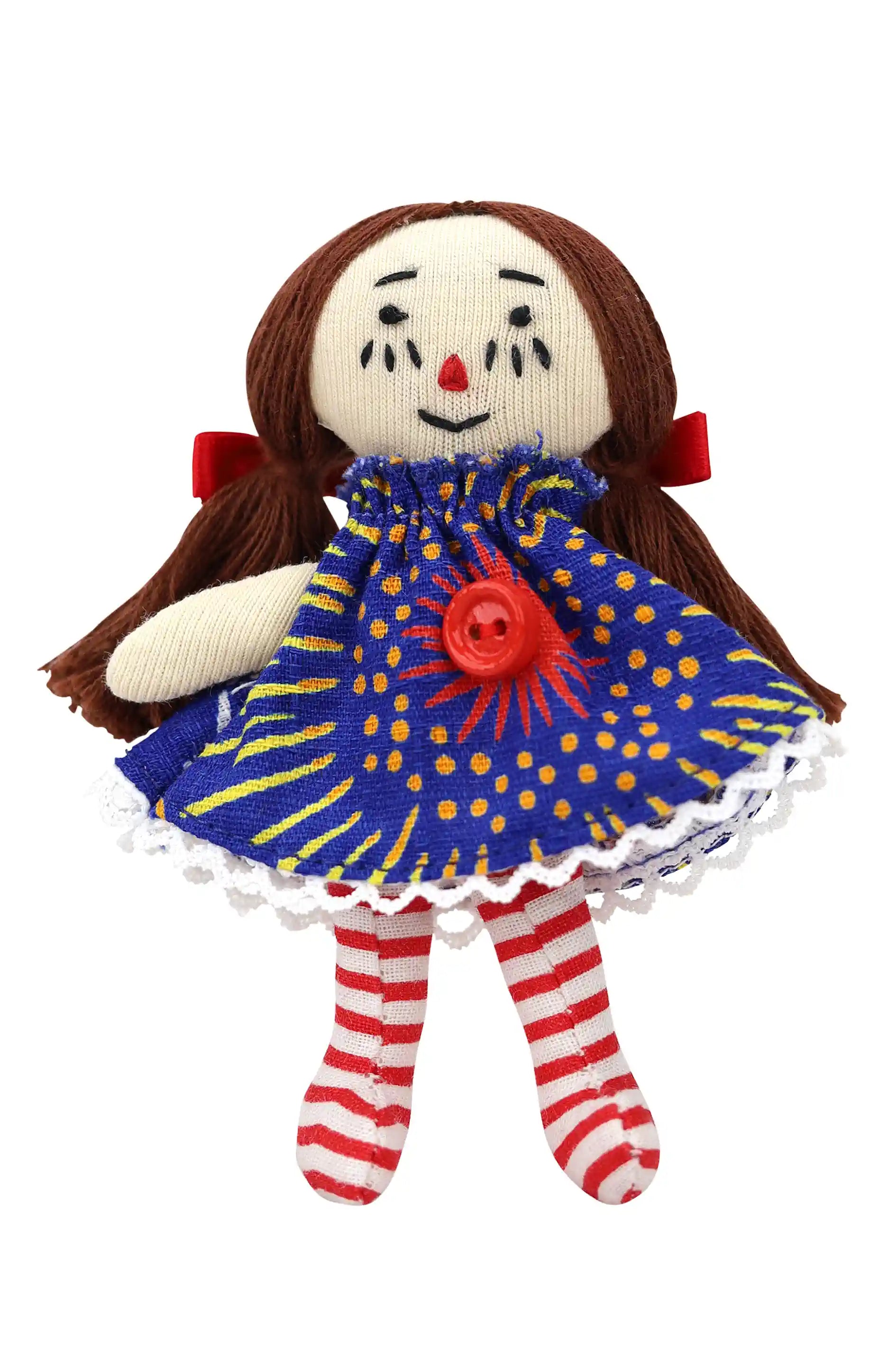 Toy doll with a blue dress featuring a red button, striped socks, and brown hair on a white background