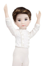 Doll wearing a white ballet outfit with arms raised on a white background
