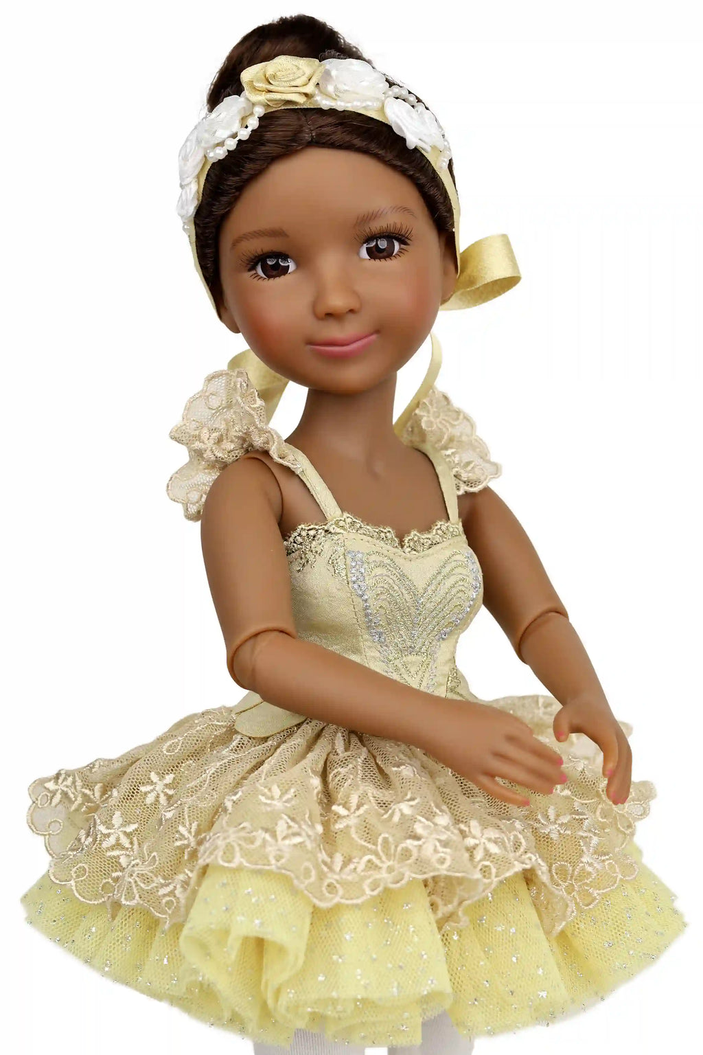 Doll in a yellow dress with lace details on a white background
