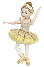 Ballerina doll in a yellow and gold dress on a white background