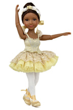 Doll in a yellow ballet outfit with white accents on a white background
