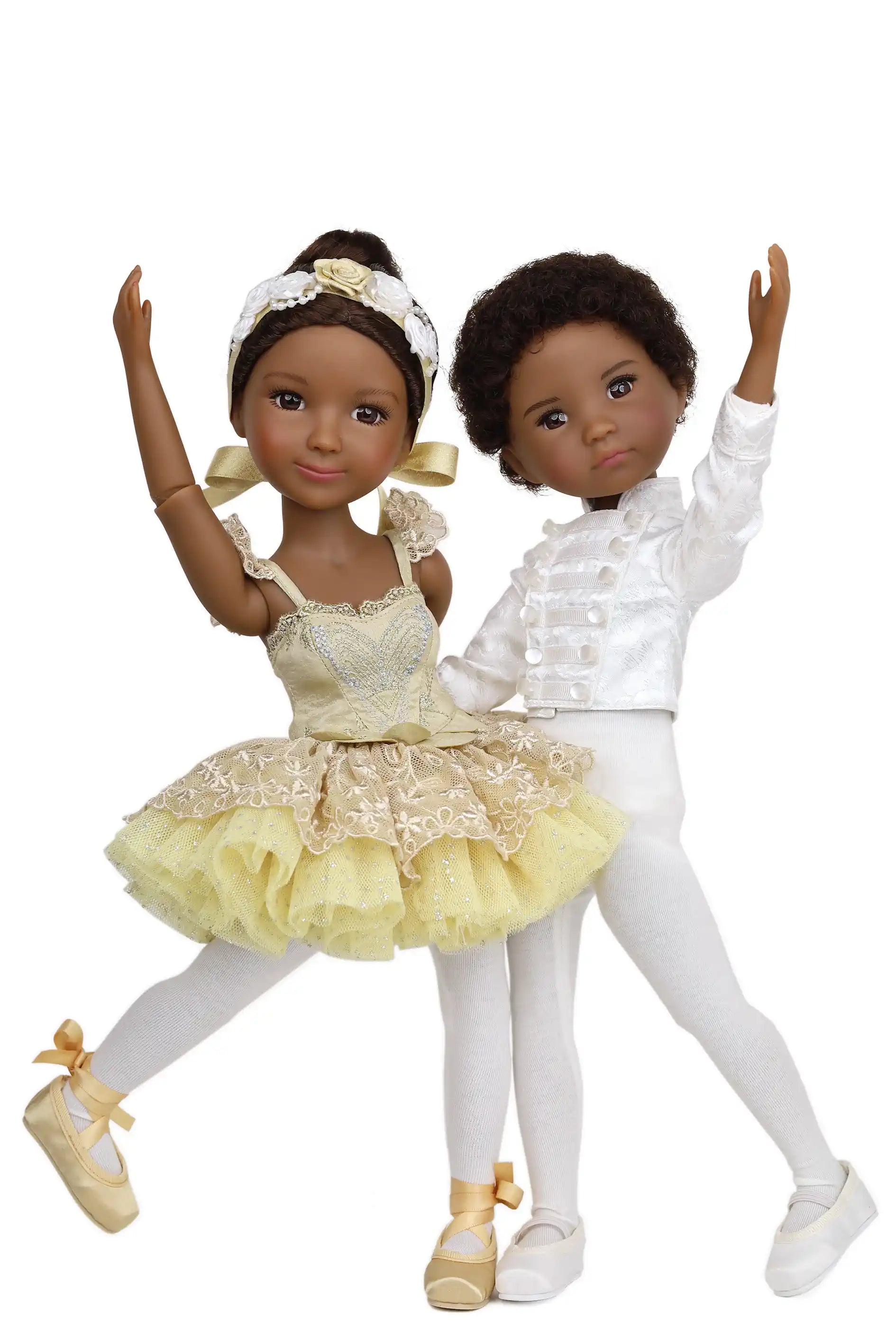 Two dolls in ballet attire on a white background