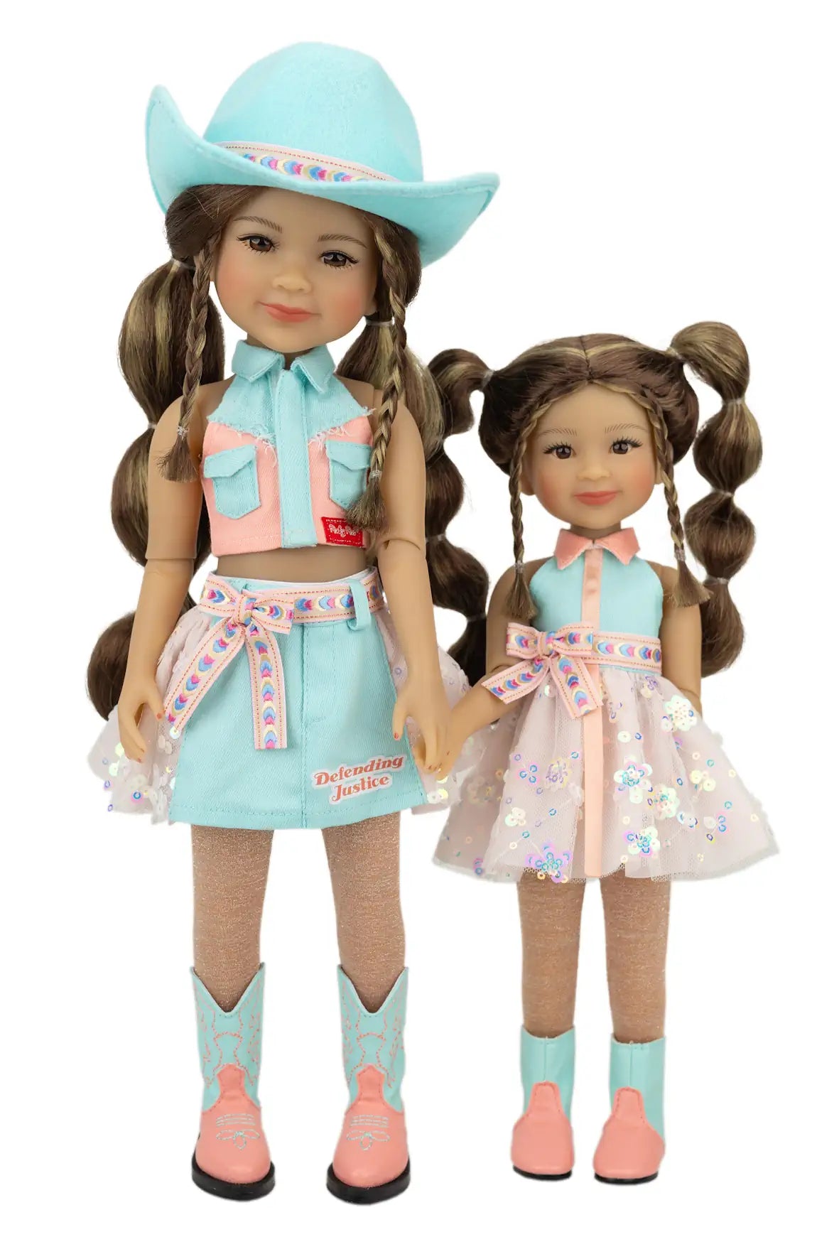 Amina and Abby in matching outfits with a turquoise cowboy hat and boots on a white background