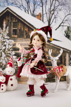 Christmas-themed doll with a snowy cabin and reindeer in the background