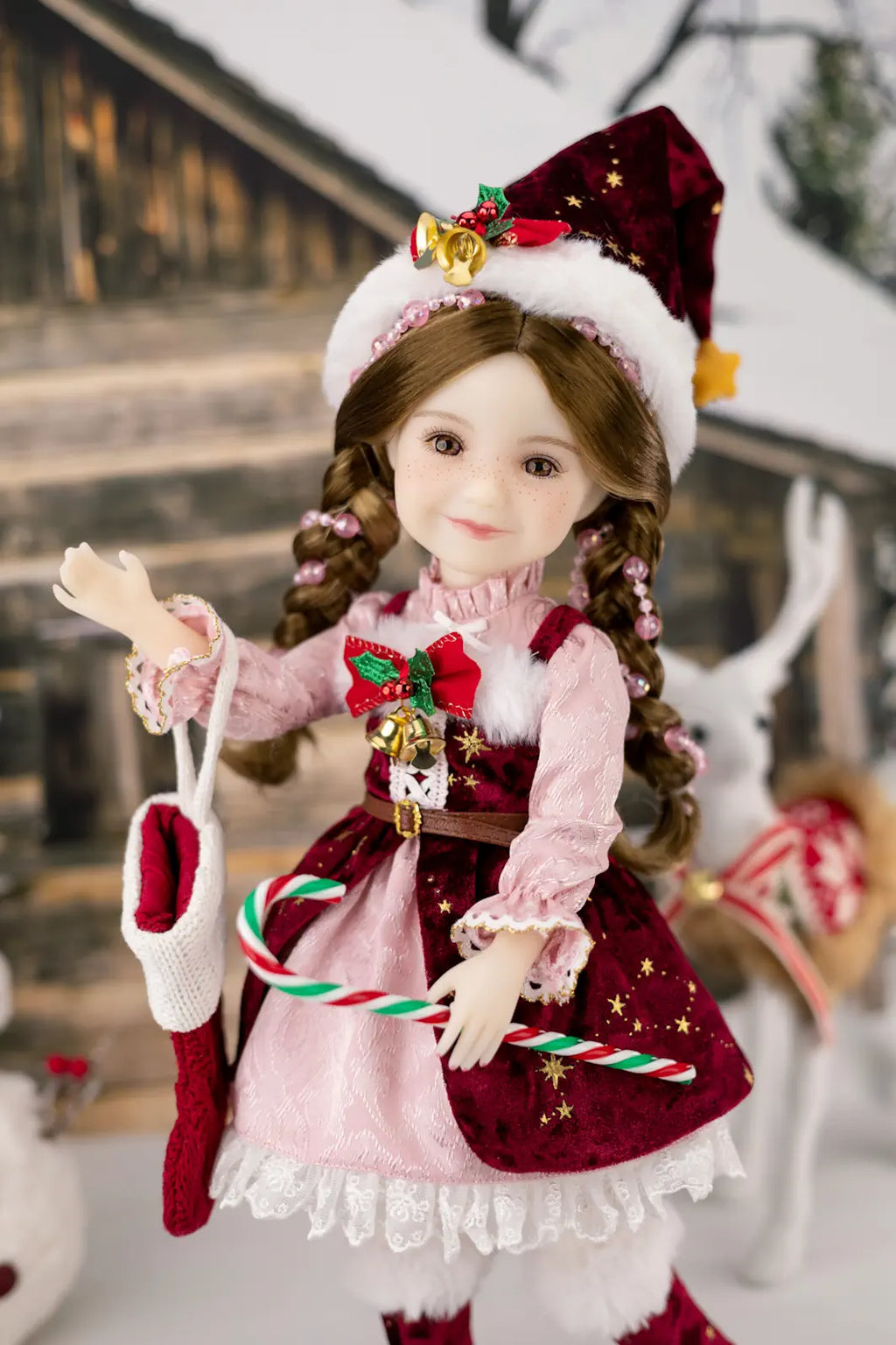 Christmas-themed doll in a festive outfit with candy canes and a Santa hat.
