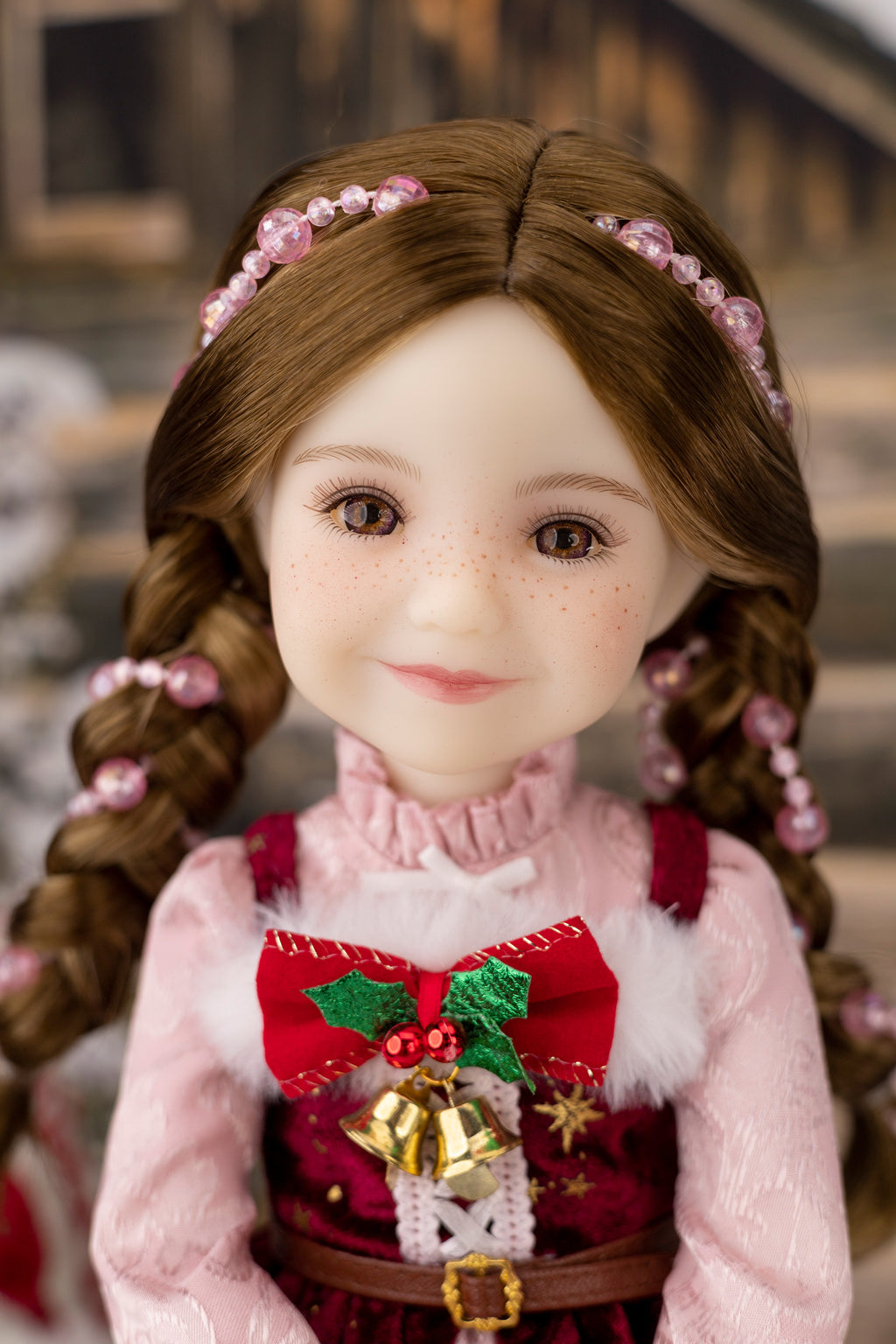 Doll with braided hair and a festive outfit against a blurred background