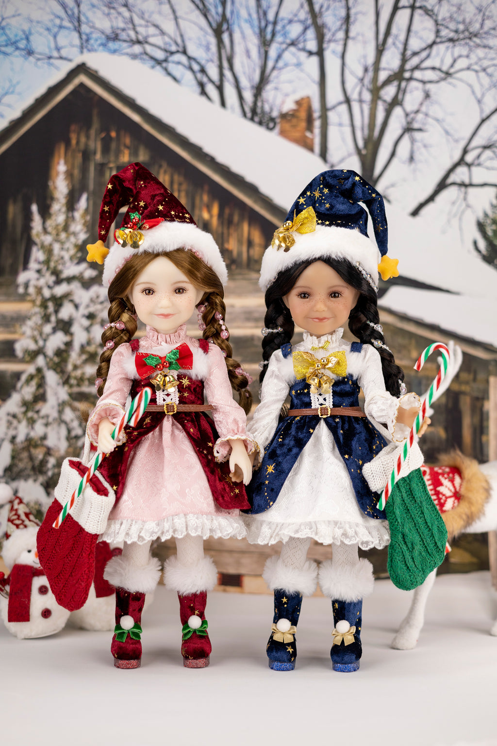 Two dolls in festive outfits with candy canes and Christmas decorations in a snowy setting.
