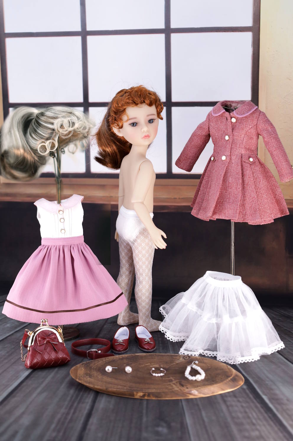 Doll with clothing and accessories on a wooden surface
