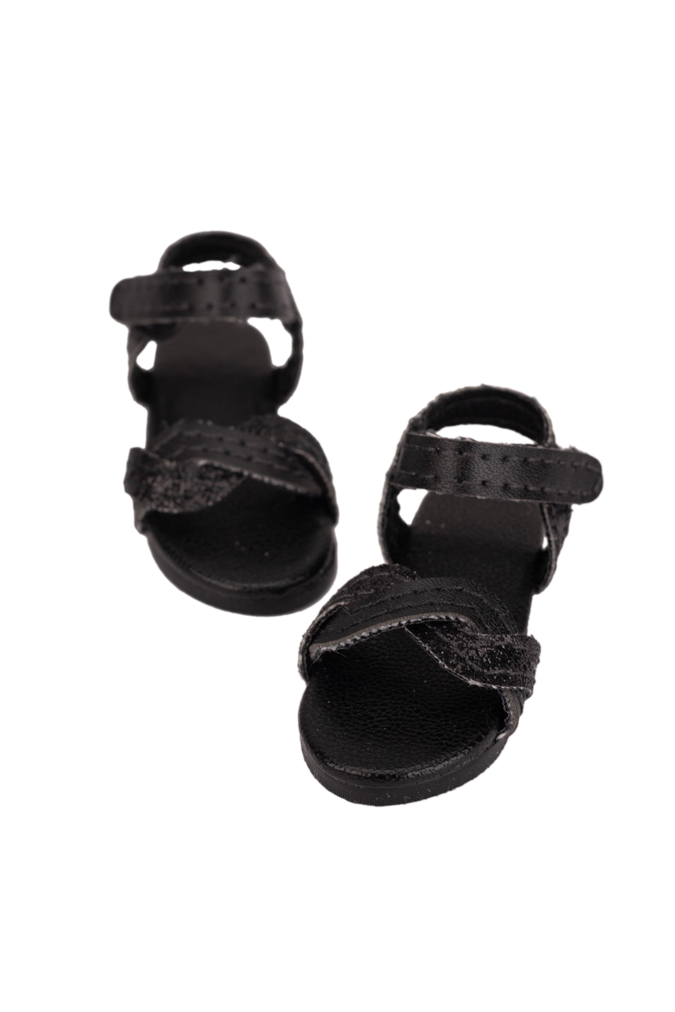 Pair of black sandals on a white background