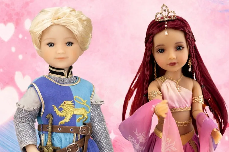 Two Ruby Red Fashion Friends Doll Artist Collab dolls, one in a blue and gold outfit with a lion emblem and the other in a pink and gold outfit with braided hair, on a pink background.