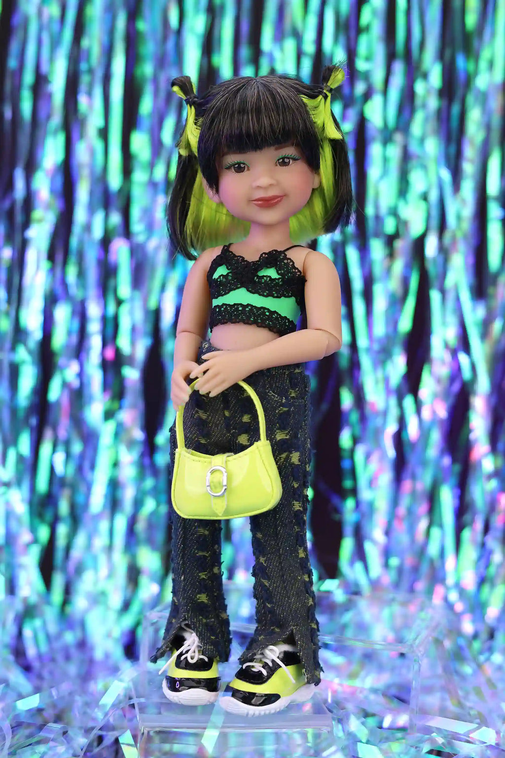 Doll with black and green outfit holding a yellow handbag against a colorful, abstract background