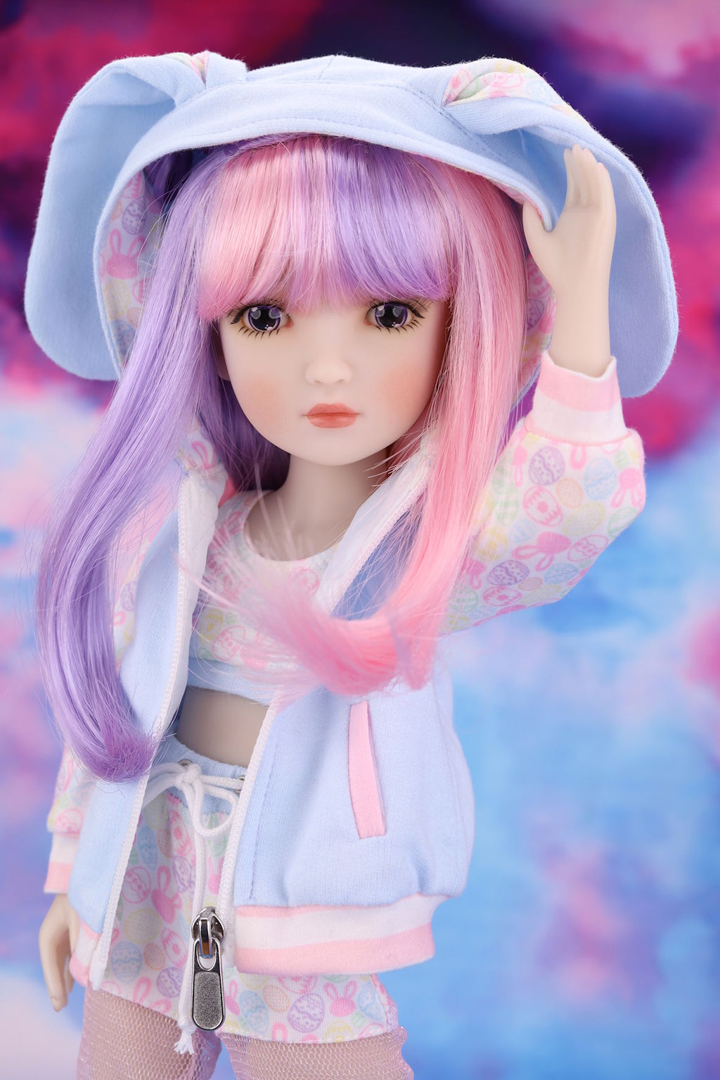 Doll with pastel-colored hair and outfit against a colorful background