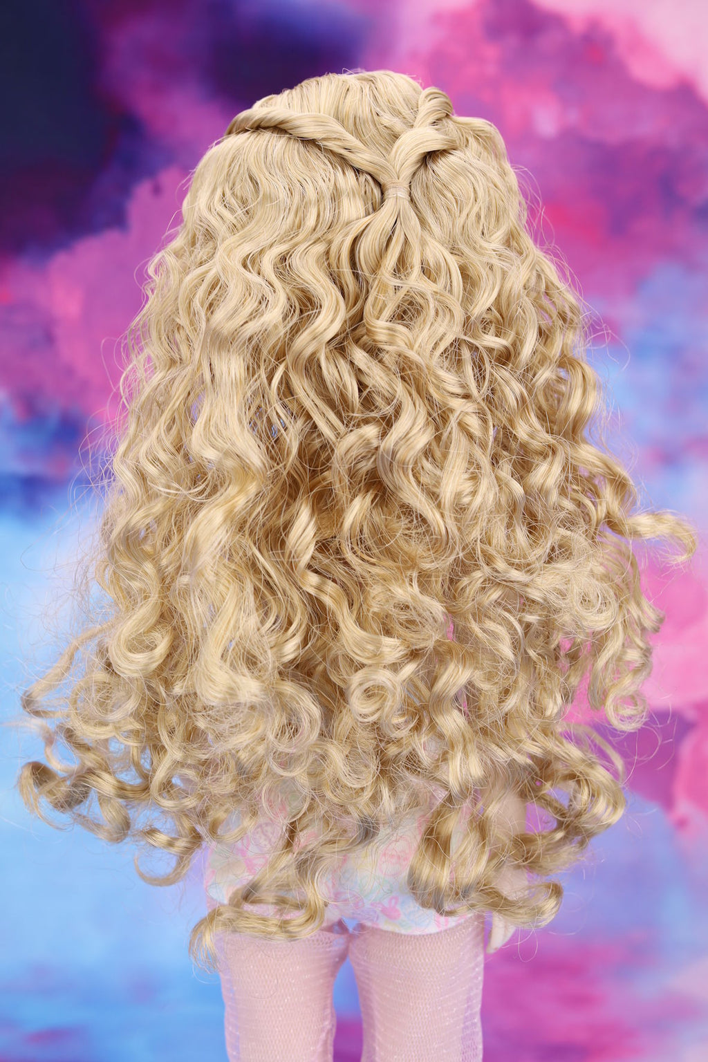 Blonde wig with braided hair on a colorful abstract background