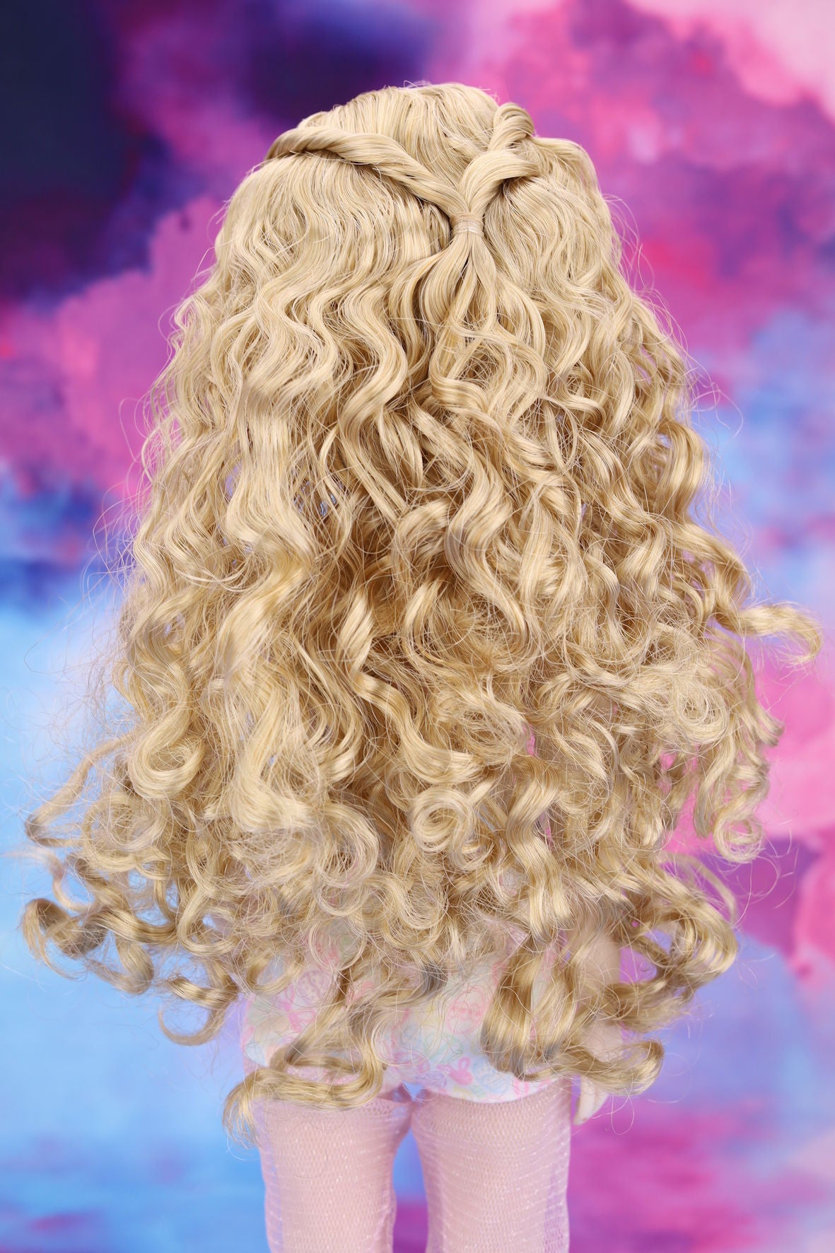 Blonde wig with braided hair on a colorful abstract background