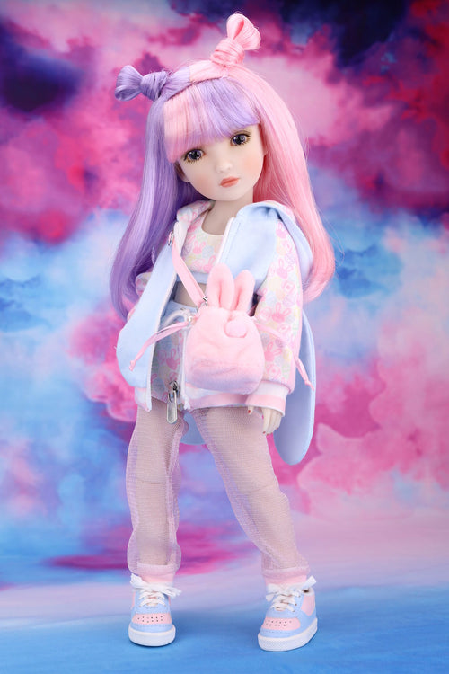 Doll with pastel-colored hair and outfit against a colorful, cloud-like background