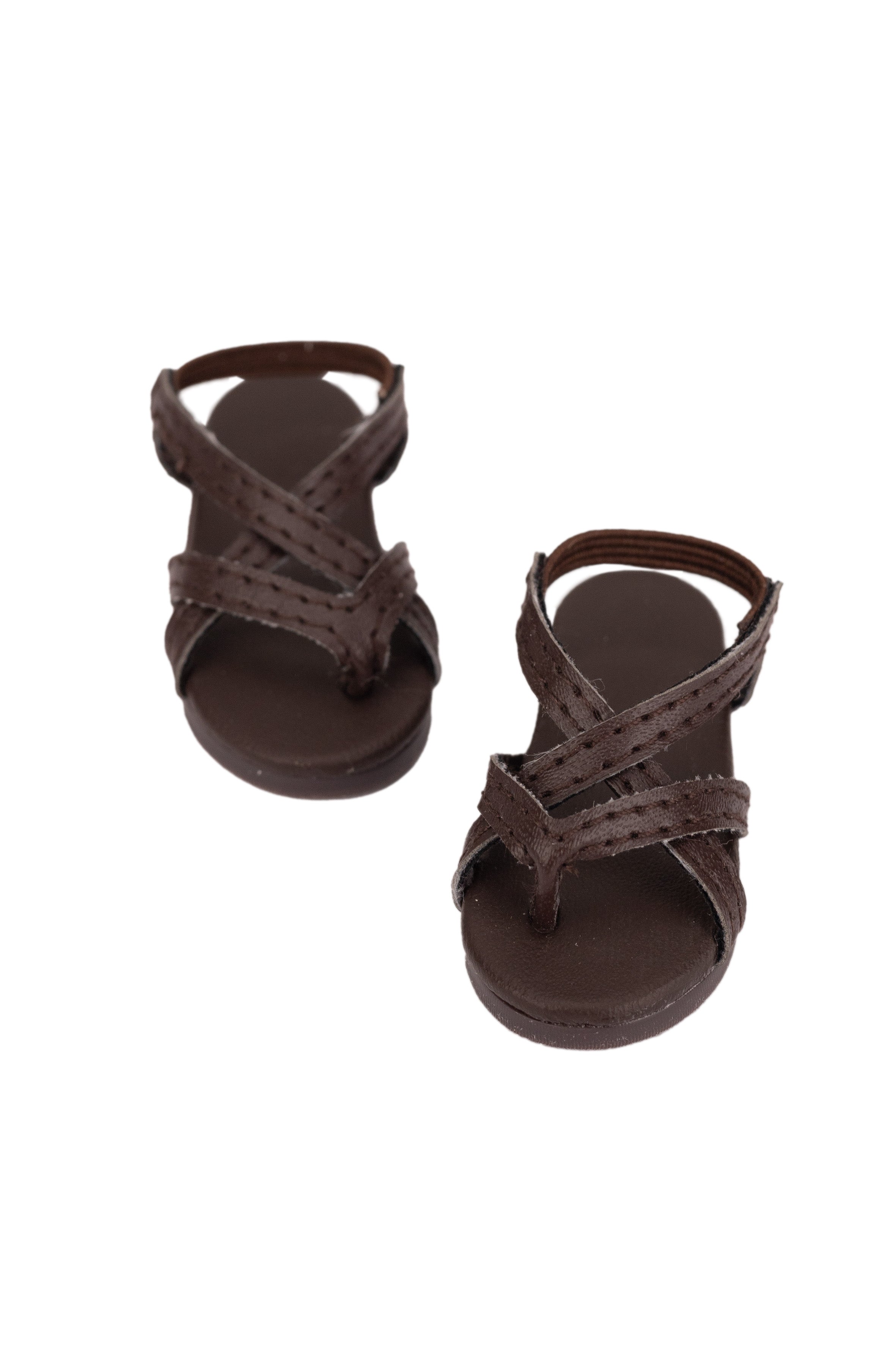 Pair of brown sandals on a white background
