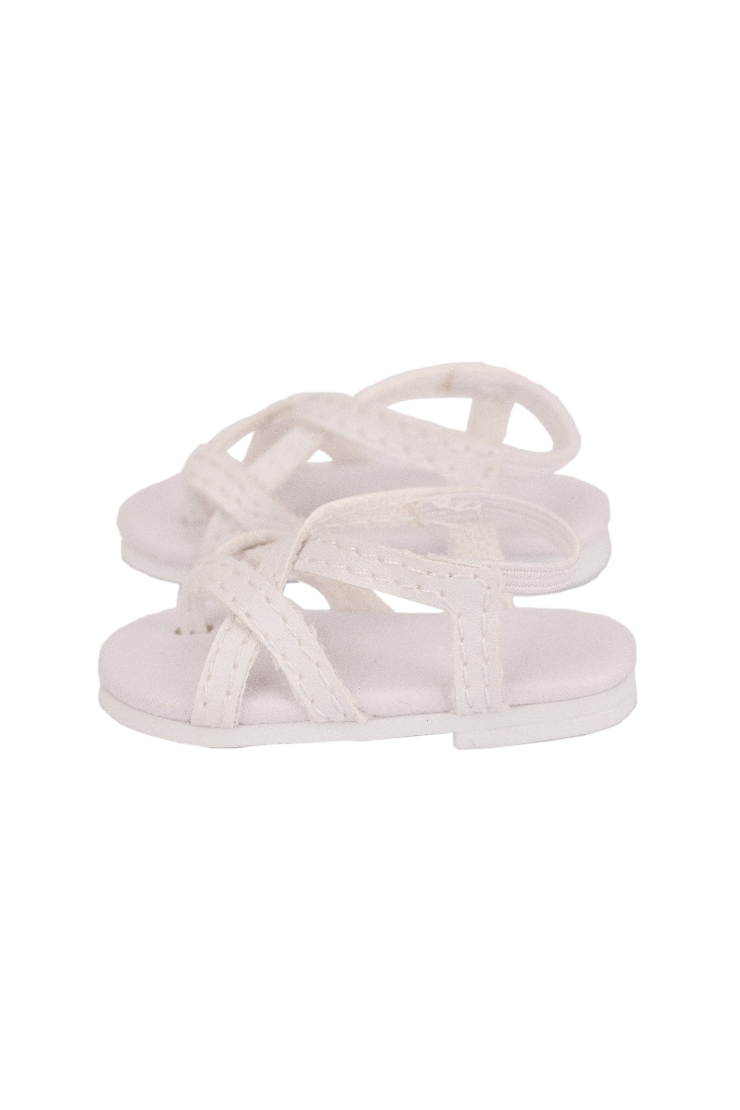 White sandal with criss-cross straps on a white background