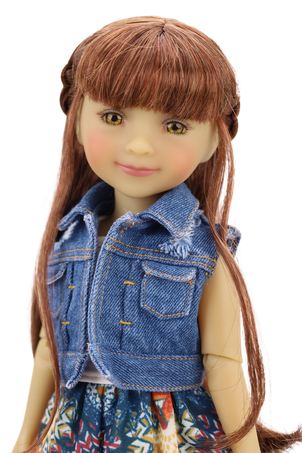 Bella wearing a denim jacket, colorful skirt, and pink shoes on a white background