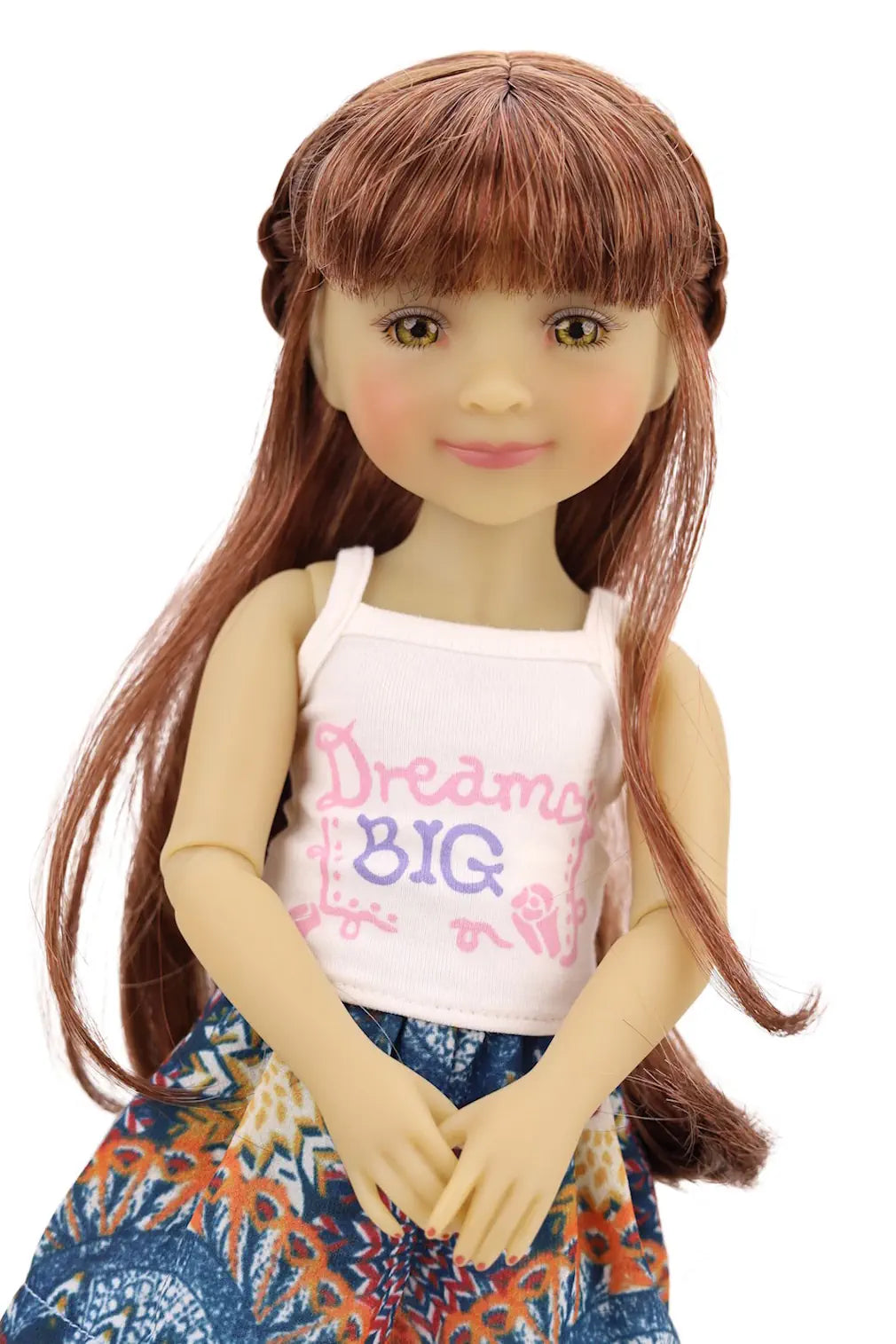 Doll with long brown hair wearing a white tank top with text and a colorful skirt on a white background