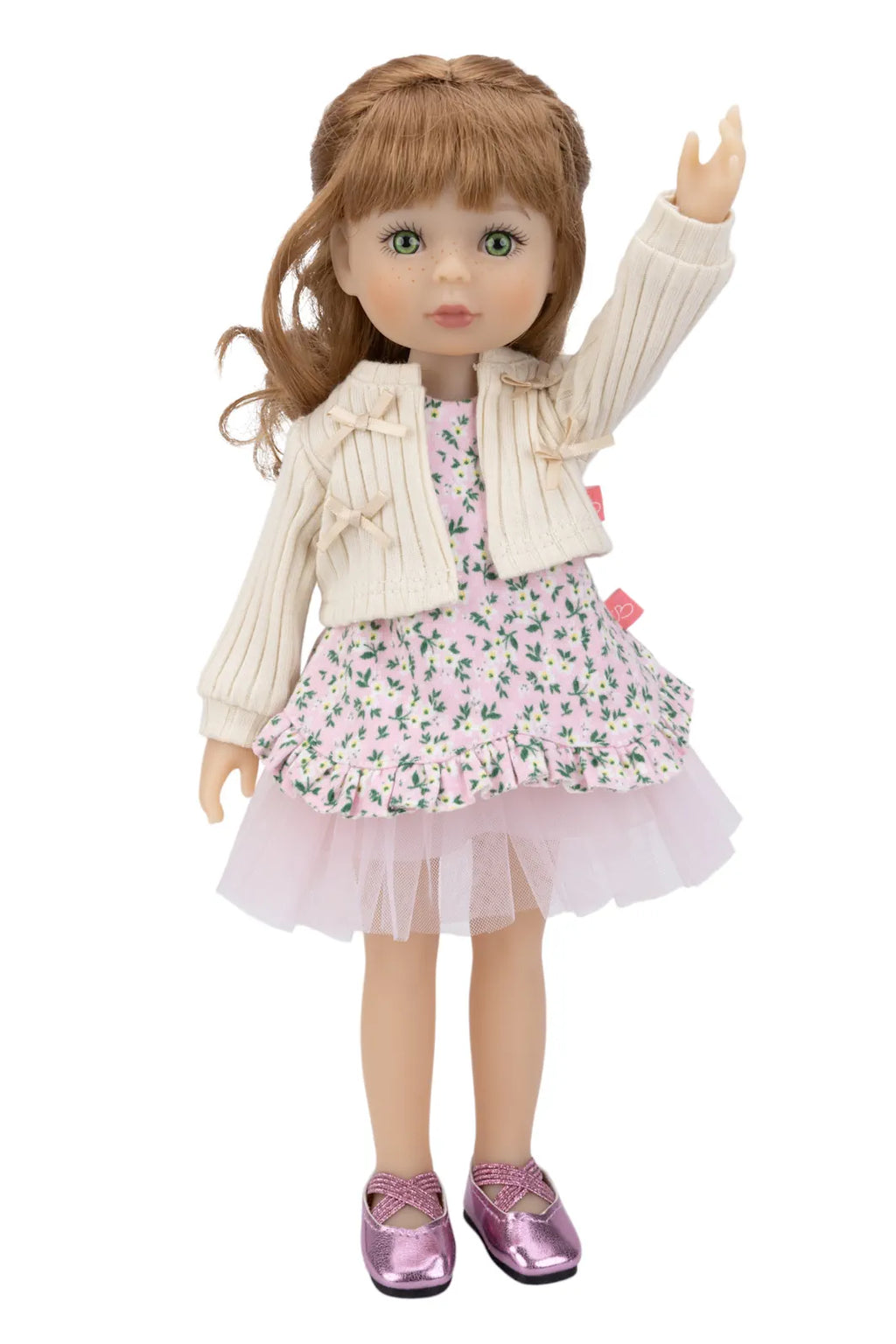 Doll wearing a floral dress with a white cardigan on a white background