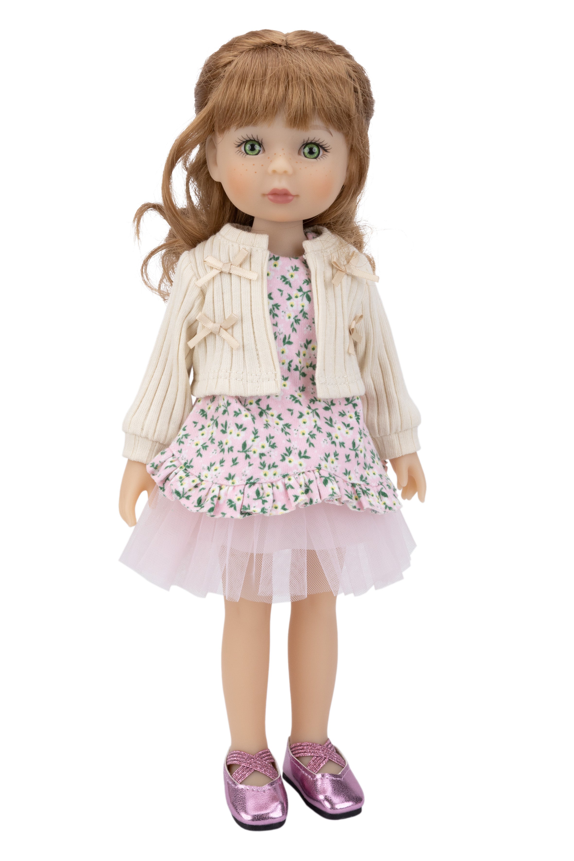 Doll wearing a floral dress with a beige jacket on a white background