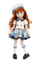 Doll with red hair wearing a blue and white checkered dress with a sailor hat on a white background