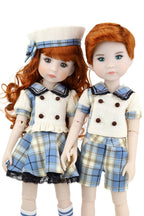 Two dolls with red hair, one in a sailor outfit and the other in plaid shorts and shirt, on a white background.